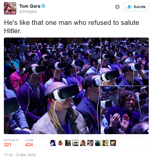 Photo of a sea of people in VR sets but one man in the crowd isn't wearing one